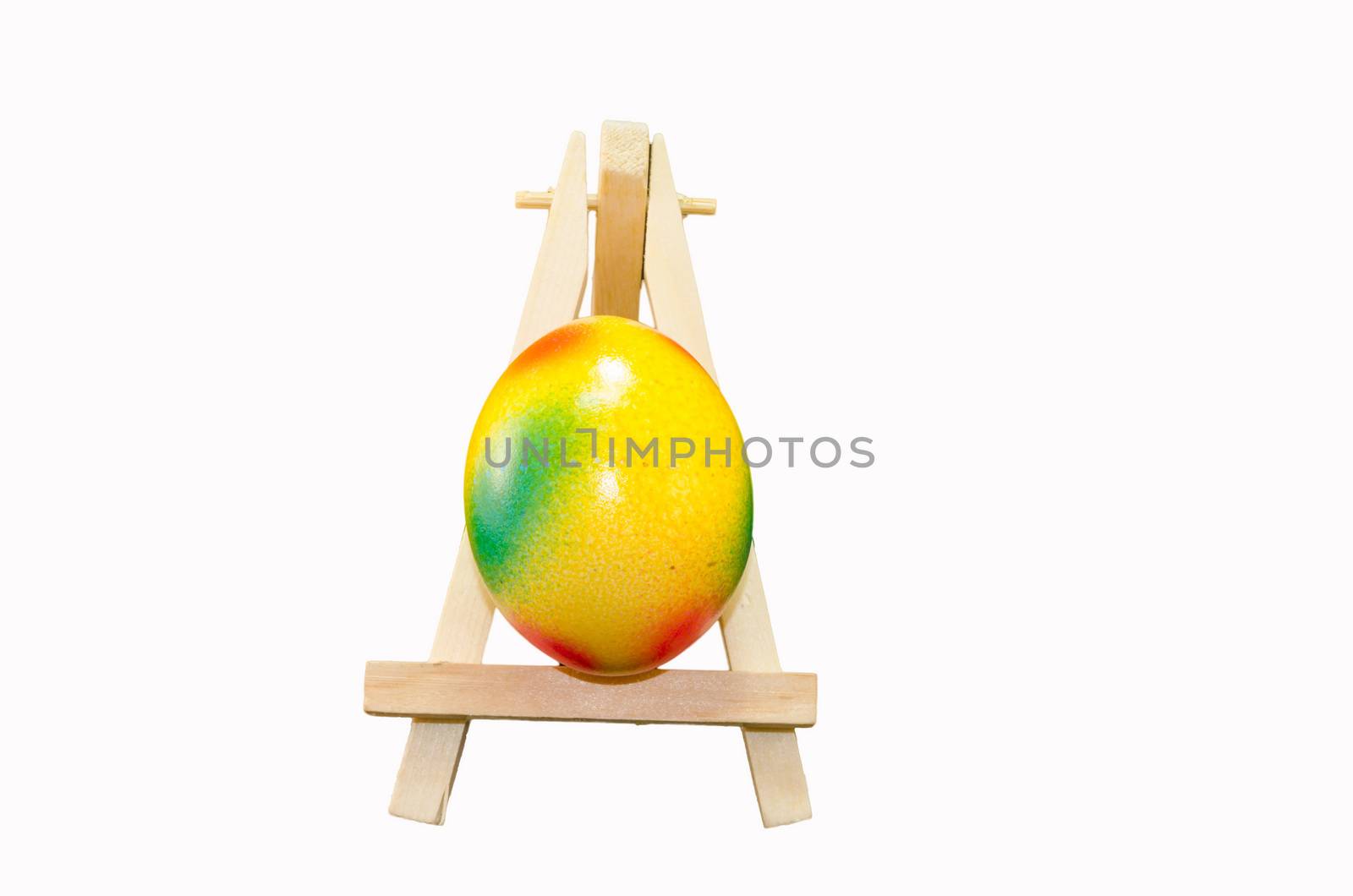 Easter is on artist easel. Easter egg painting.