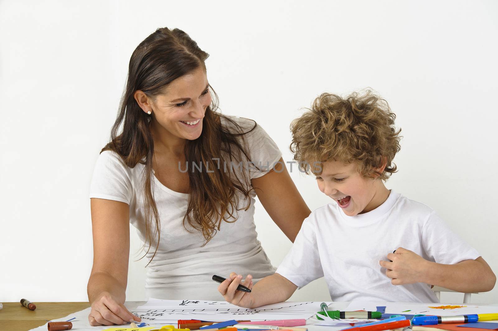 Mother teaches her child how to draw