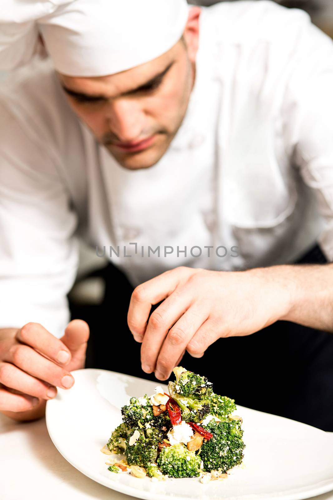 Male carefully arranged broccoli salad in plate