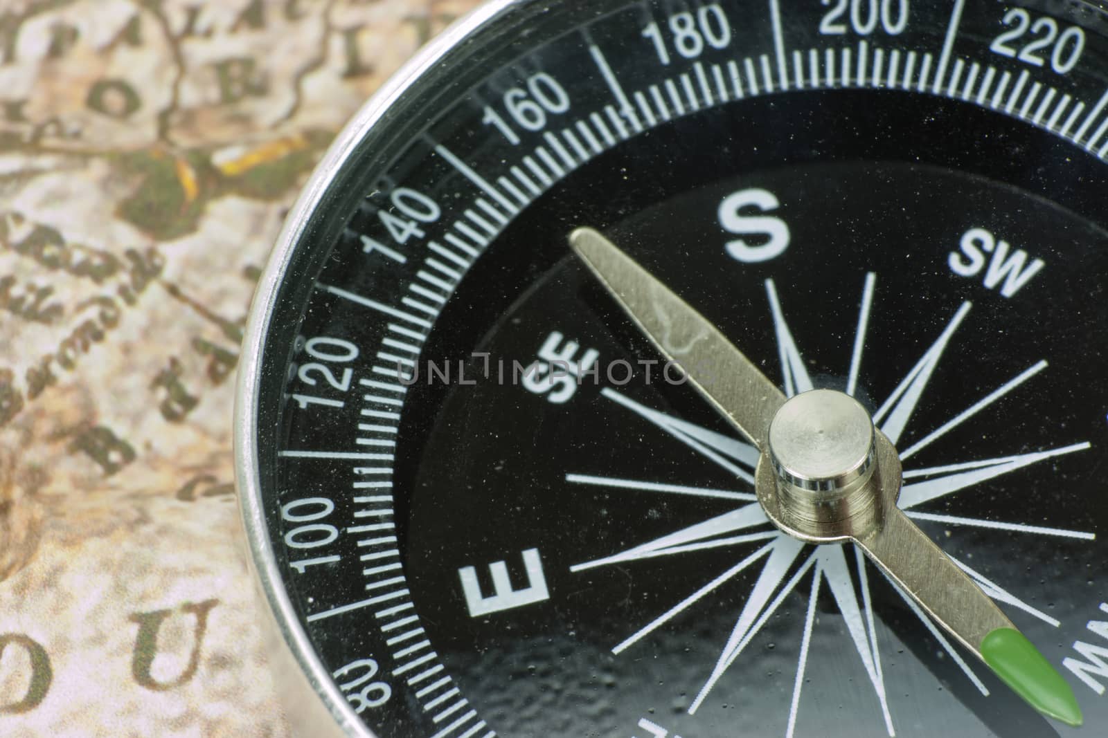 Close up of a compass on an old map