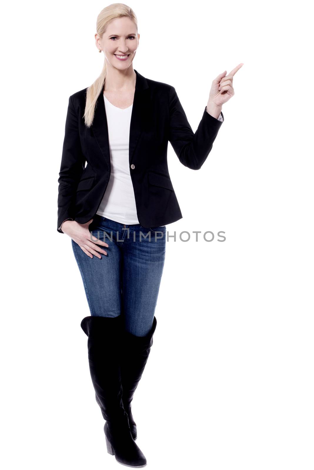 Trendy woman pointing her finger to copy space