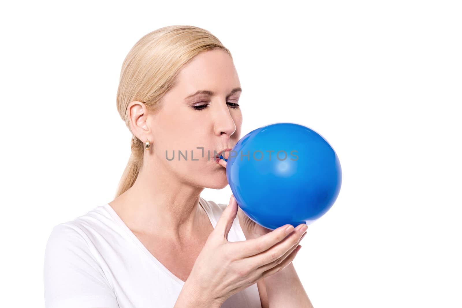 Woman inflating balloon for a party