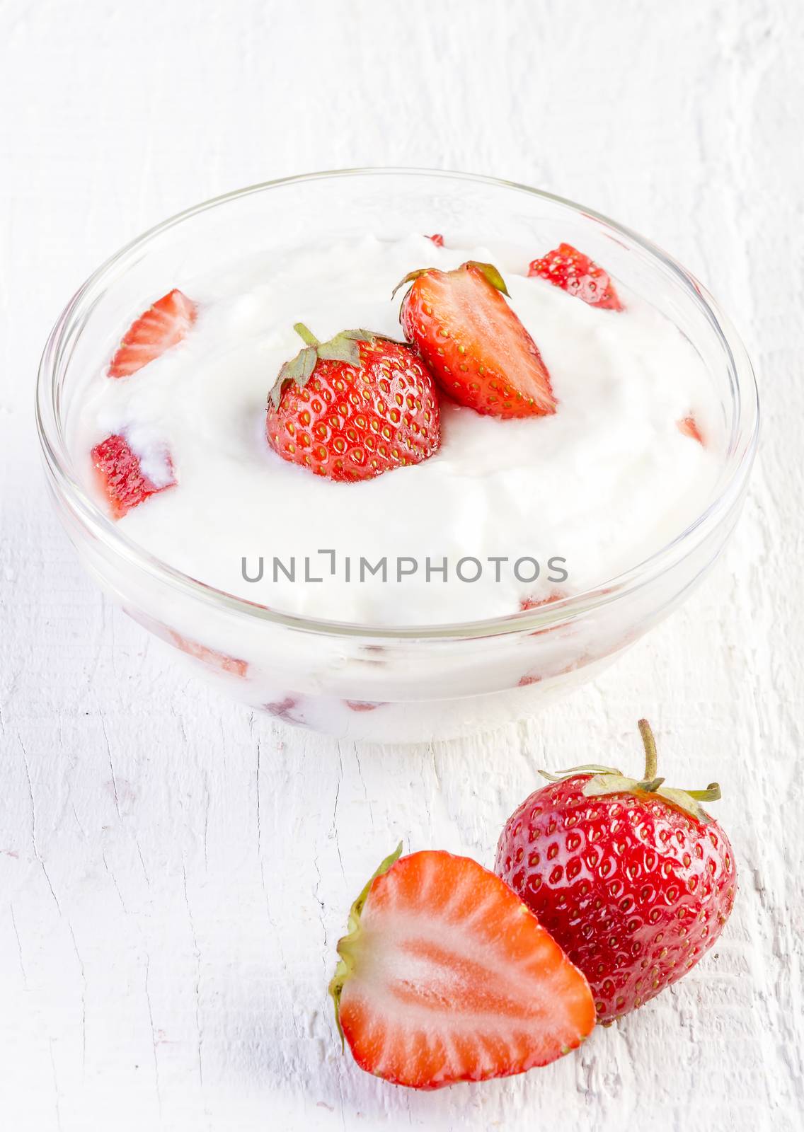 fresh organic yogurt with strawberries on wooden by manaemedia