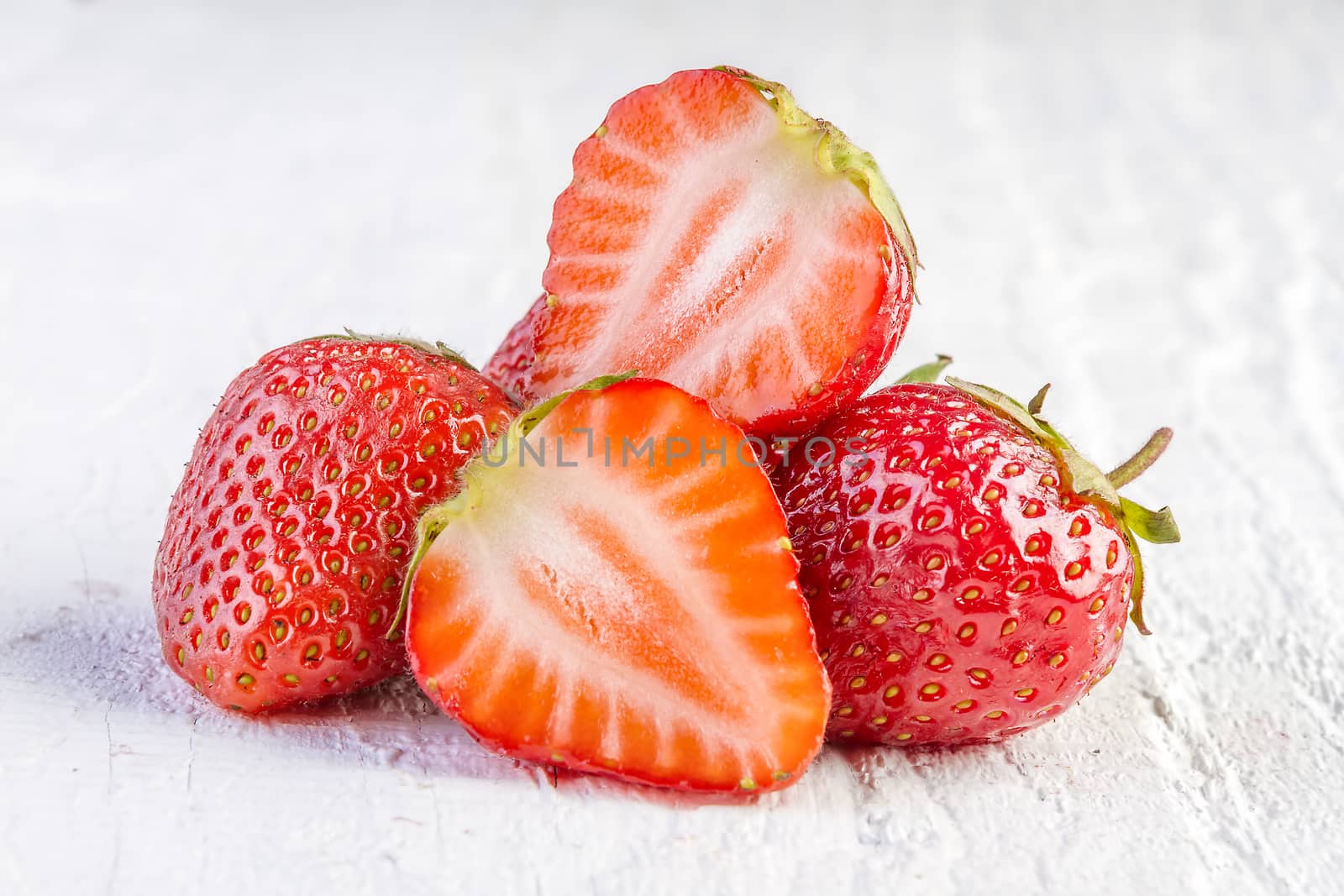 strawberries on white wooden  by manaemedia