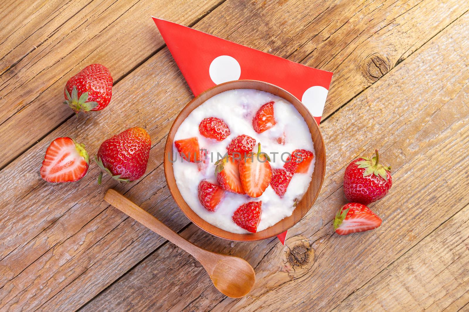fresh organic greek yogurt with strawberries on wooden by manaemedia