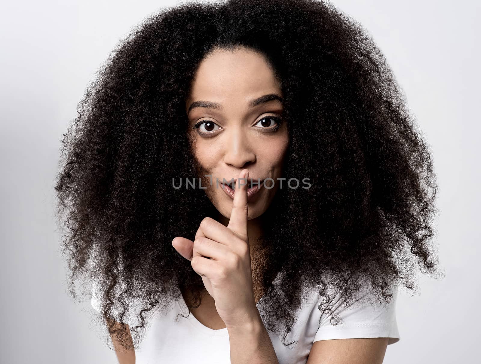 Young woman making a silence gesture