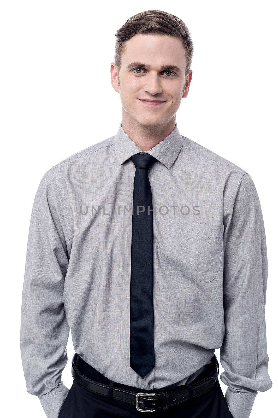 Confident male executive with hands in his pockets