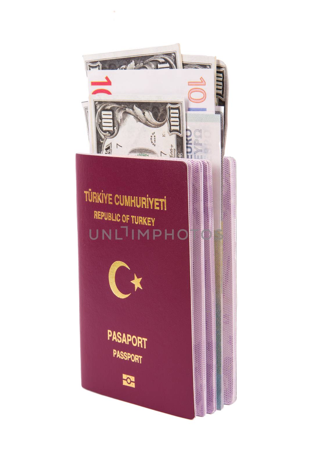 Close up front view of a Turkish passport with euro and dollar banknotes inside, isolated on white background.