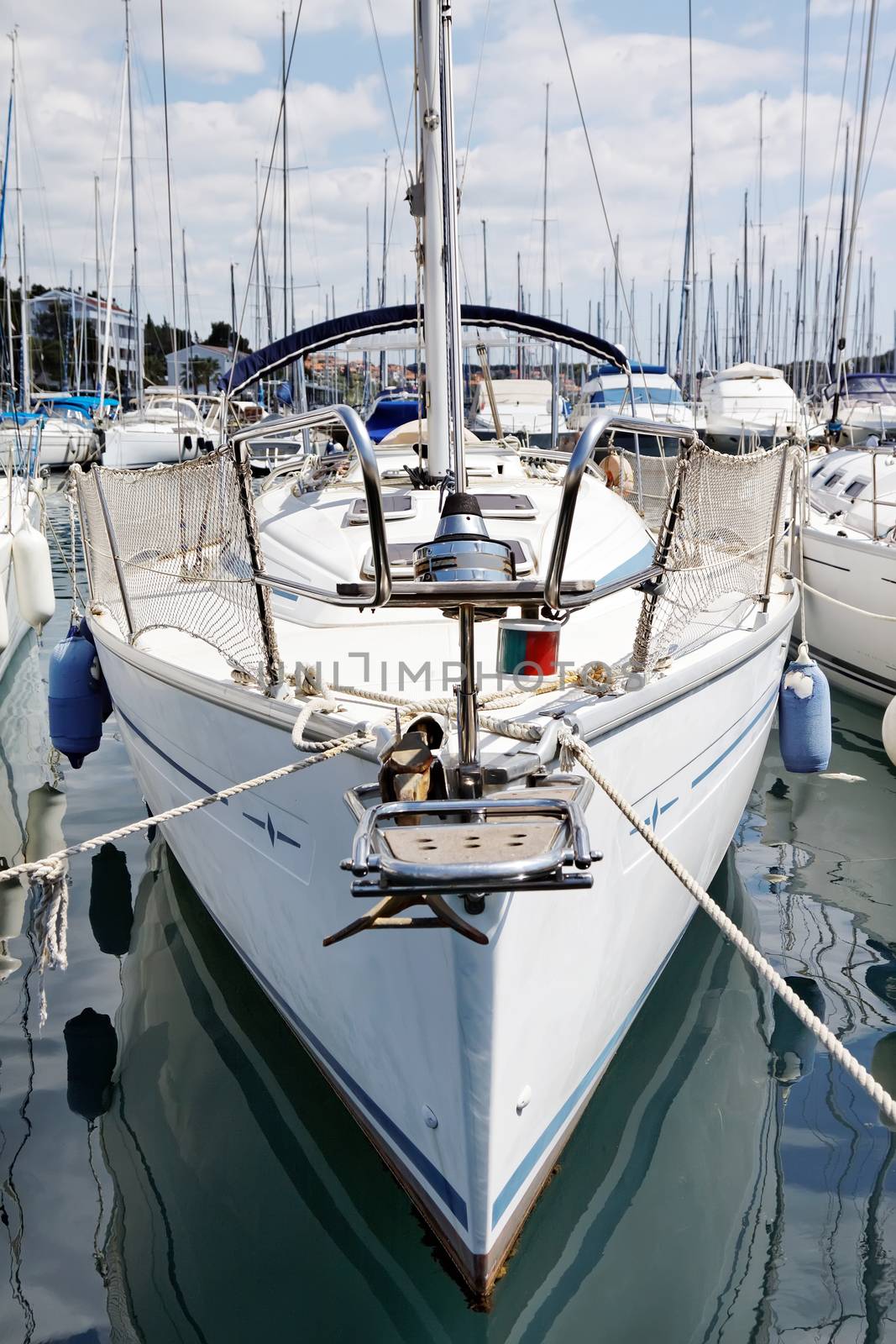 sailboat anchored in port, front view