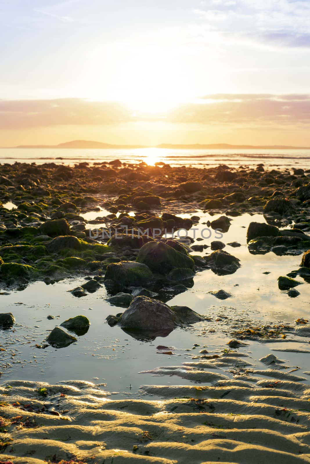 reflections at rocky beal beach near ballybunion on the wild atlantic way ireland with a beautiful yellow sunset