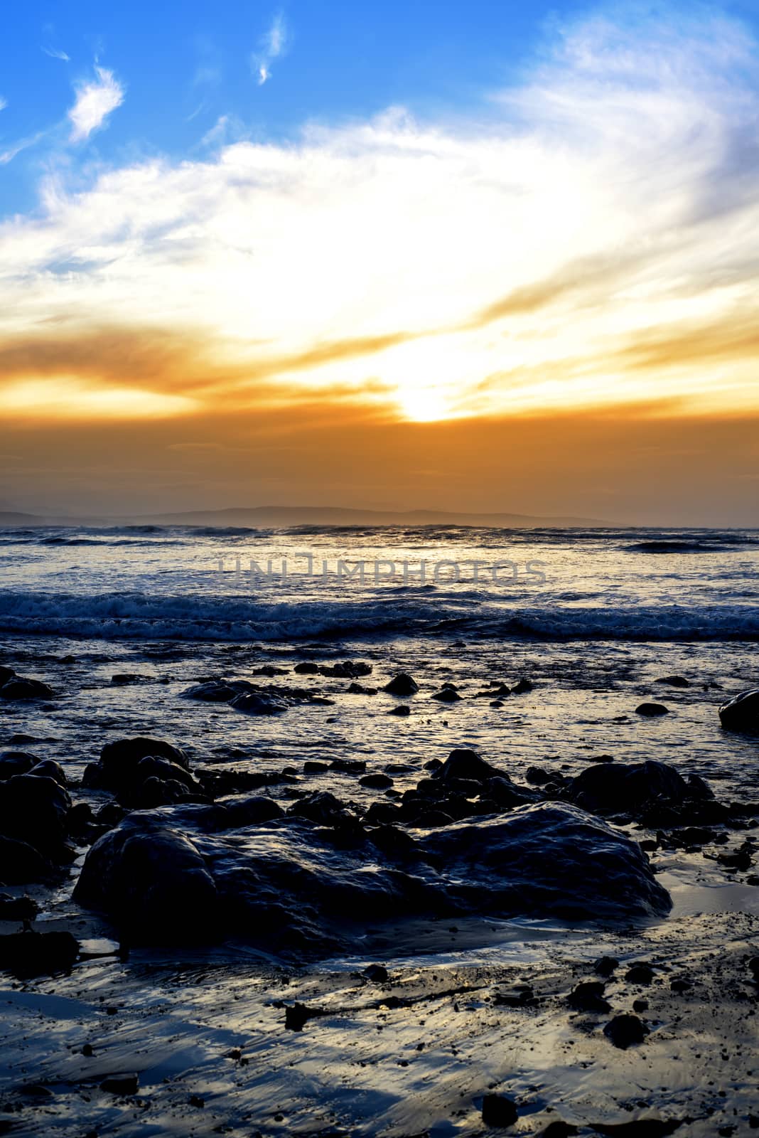 reflections at rocky beal beach near ballybunion on the wild atlantic way ireland with a beautiful yellow sunset