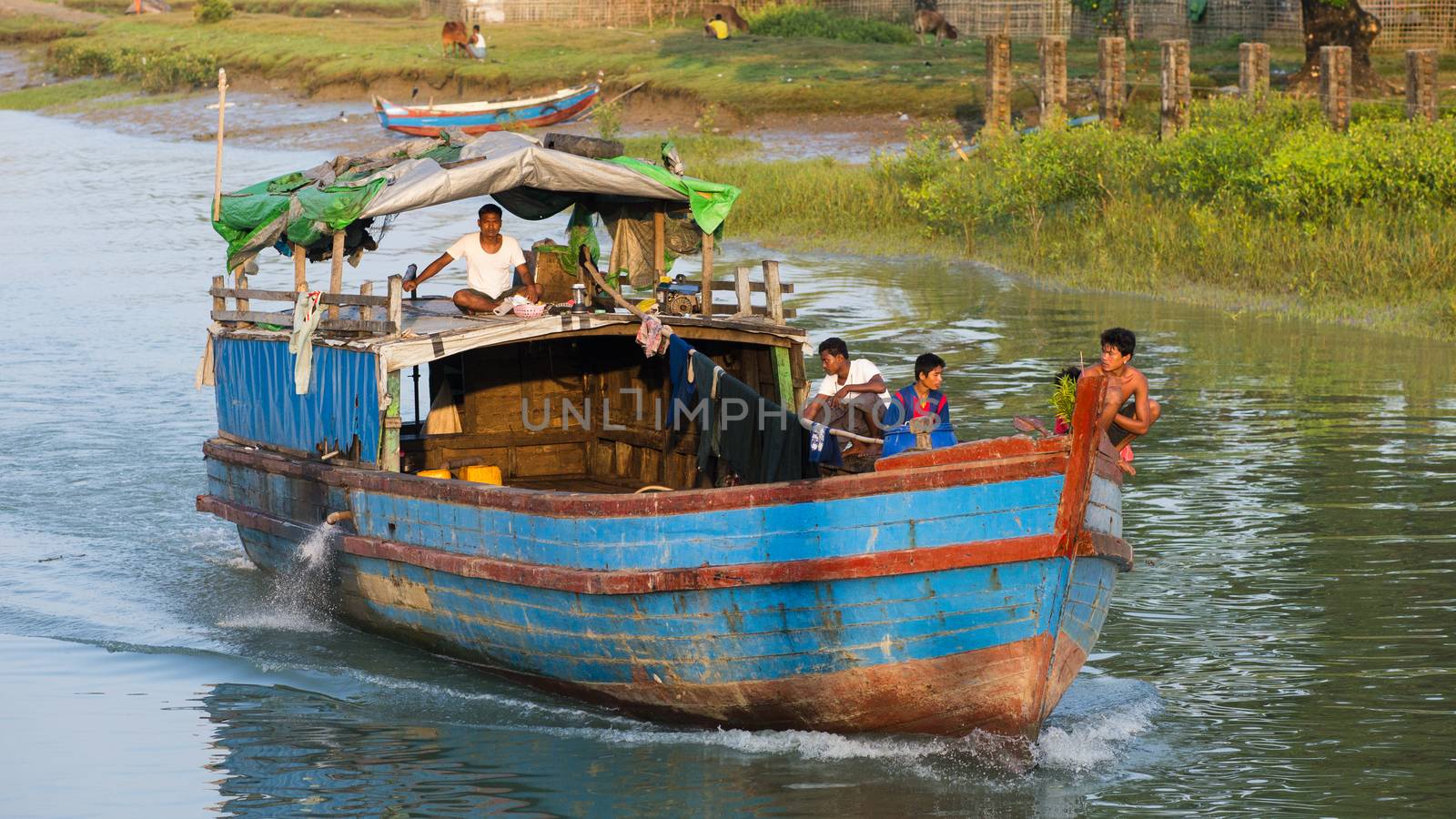 Sittwe, Rakhine State, Myanmar - October 16, 2014: Cargo vessel navigating a canal near Sittwe, the capital of the Rakhine State in Myanmar.