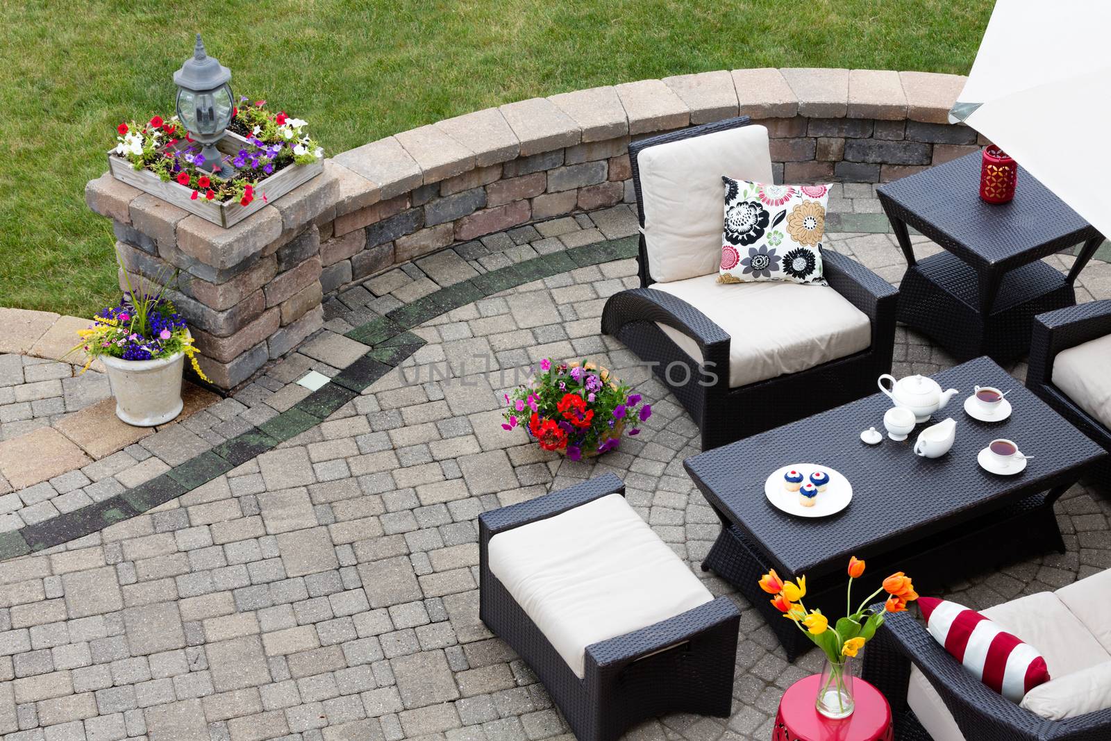 Brick paved patio with patio furniture by coskun