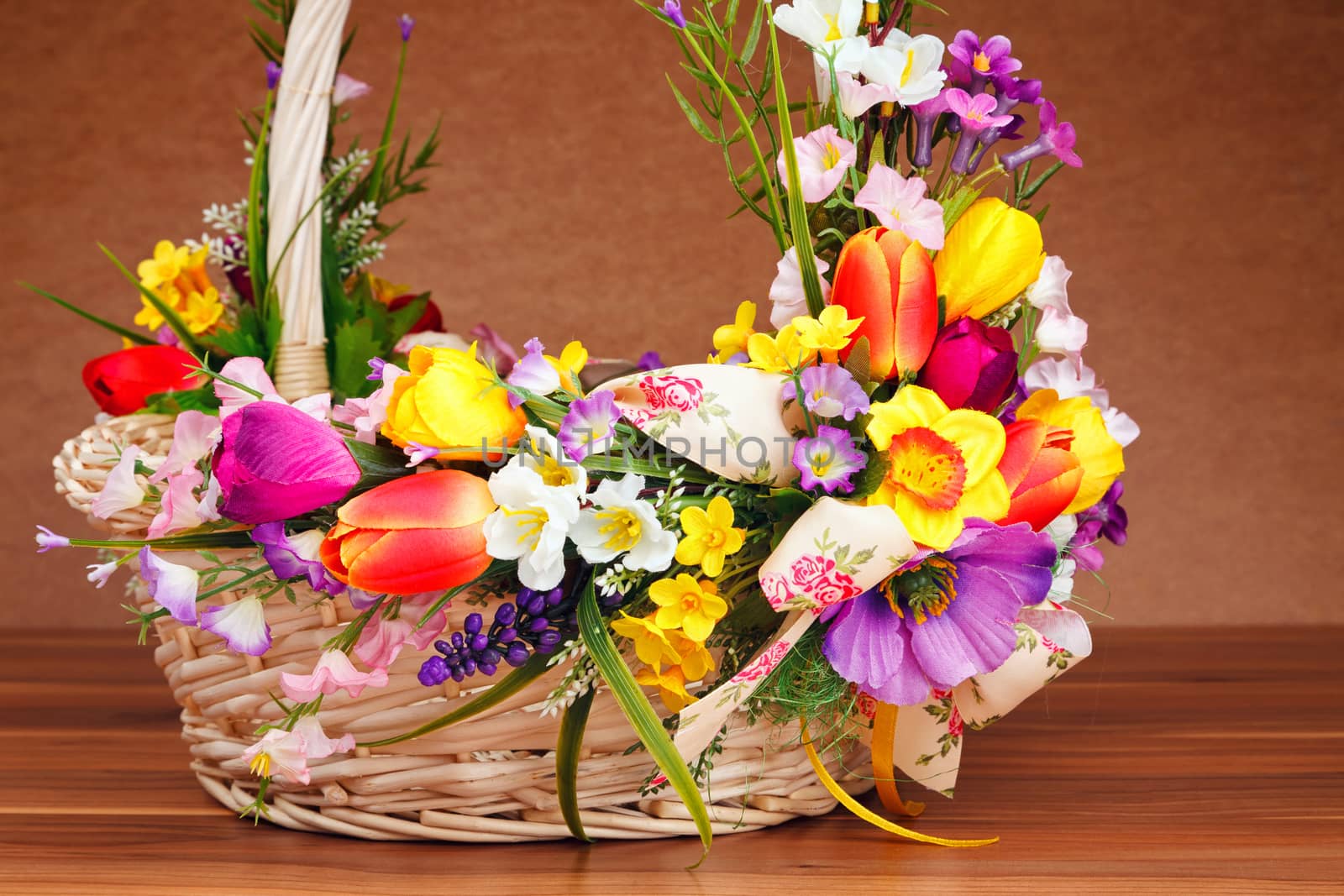 basket decorated with flowers on wooden table