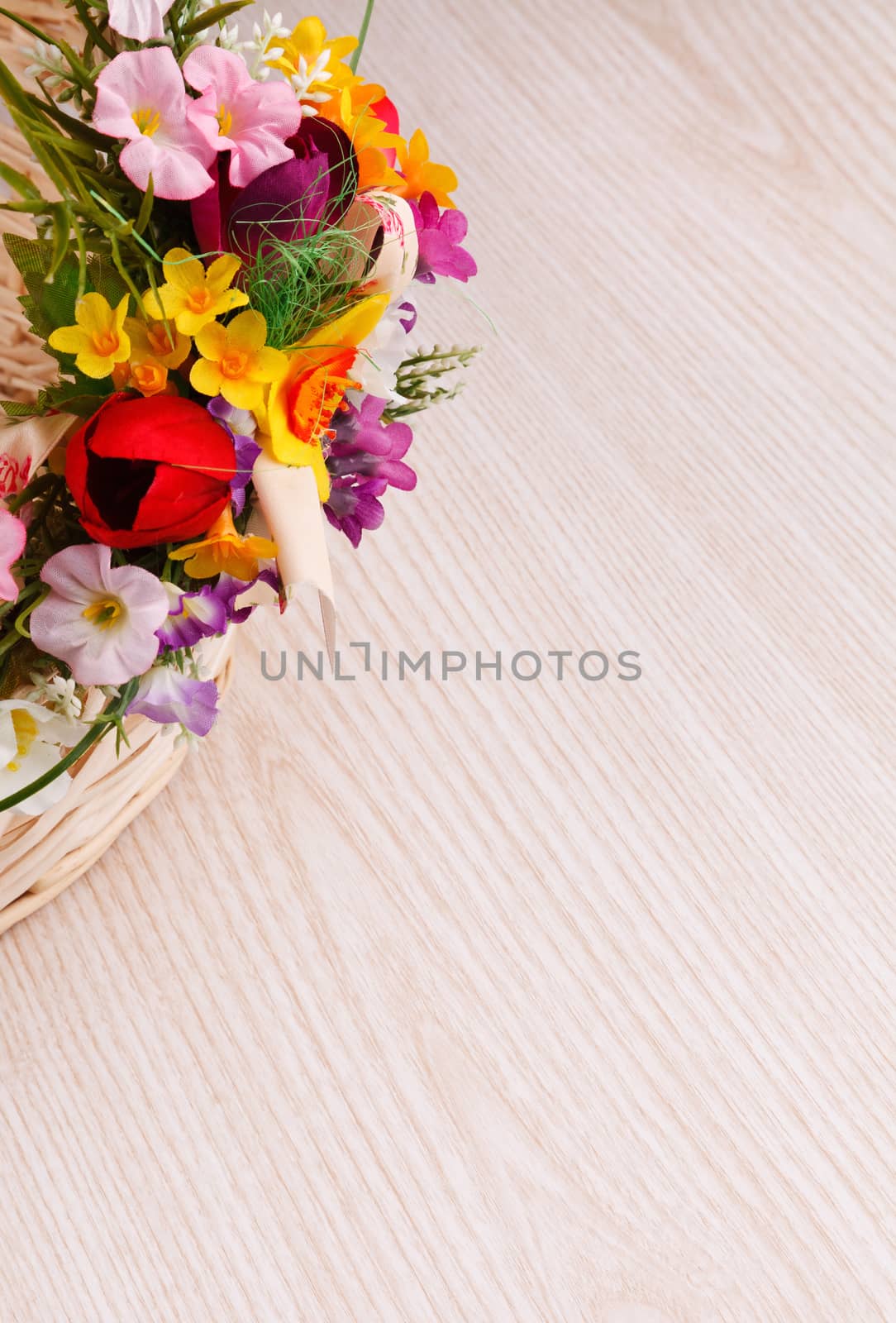 artifical flowers on a wooden background