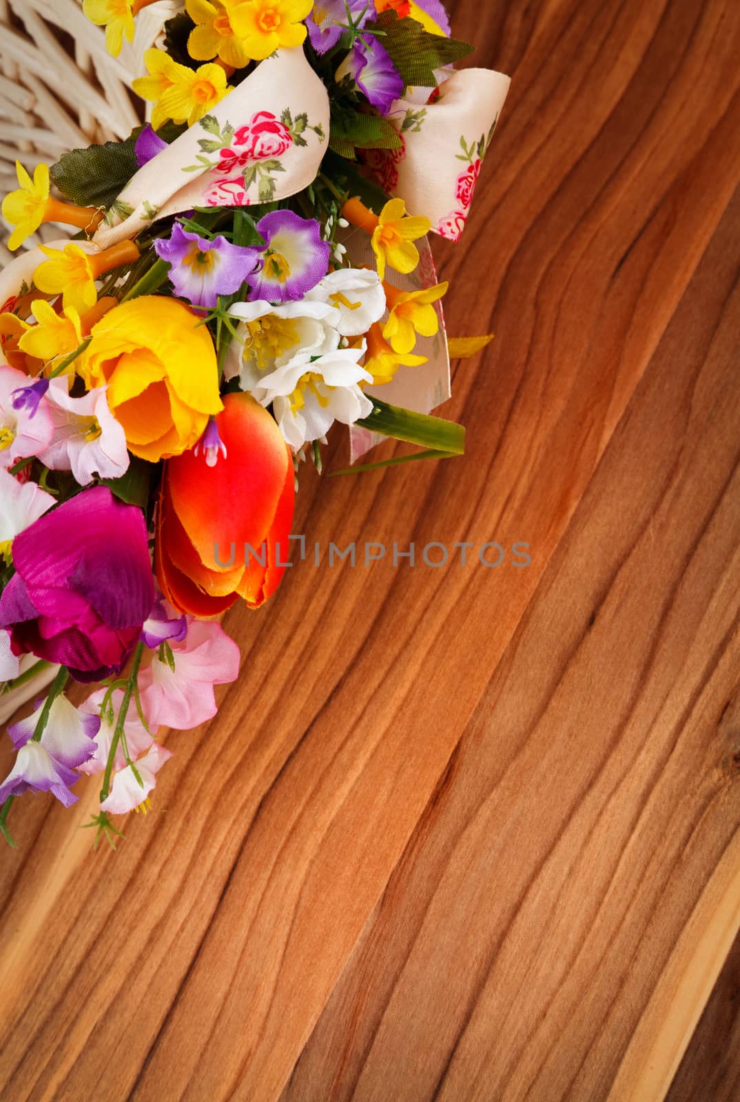 artifical flowers on a wooden background