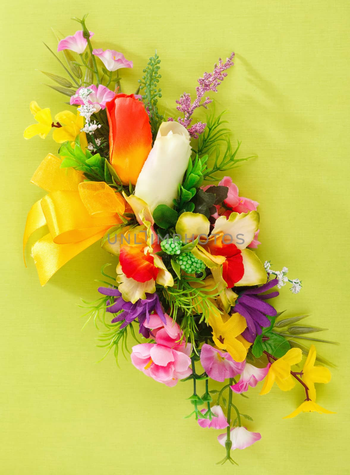 artificial flower arrangement on a yellow background with blank  for advertisement