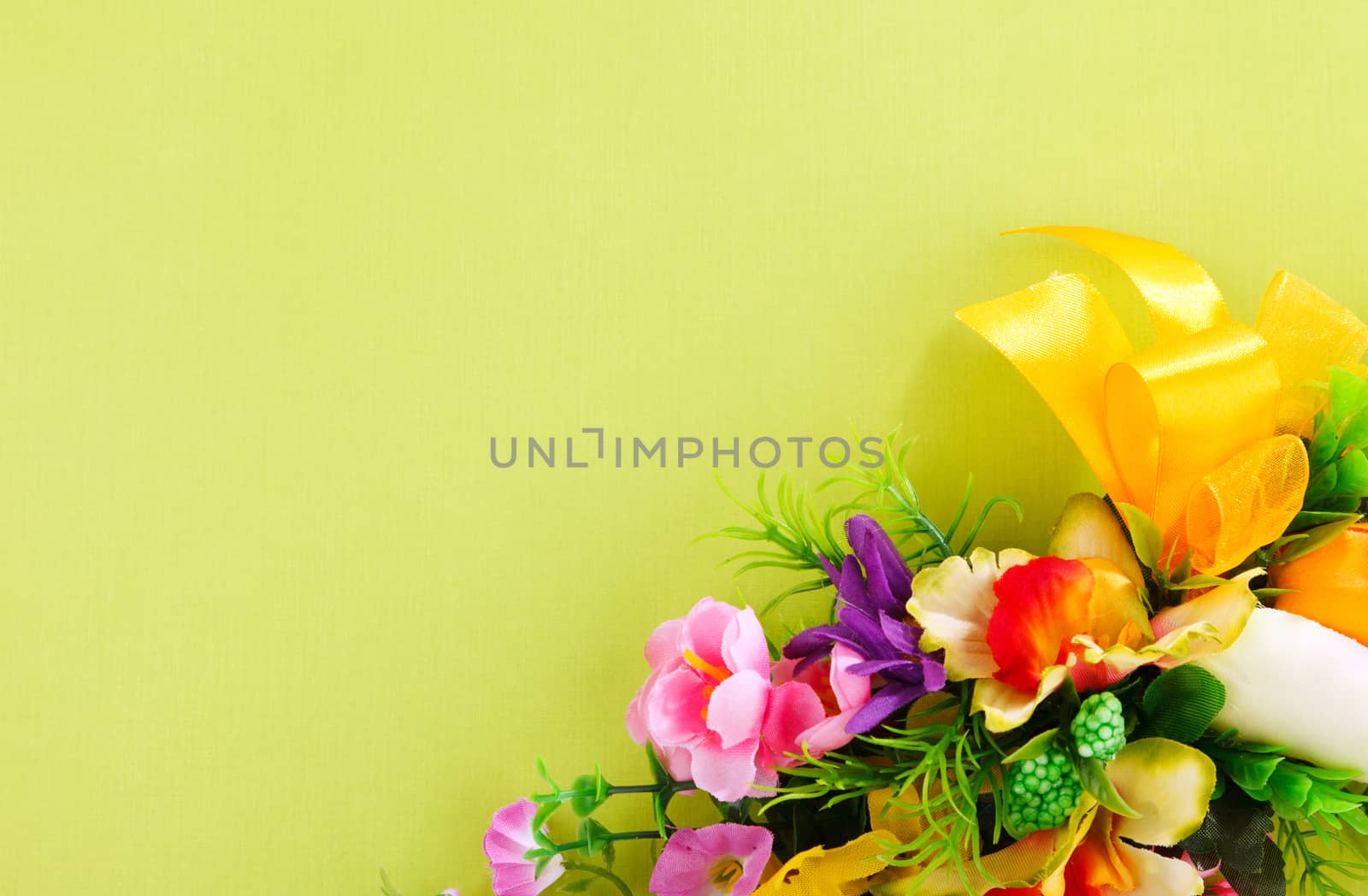 artificial flower arrangement on a yellow background with blank  for advertisement