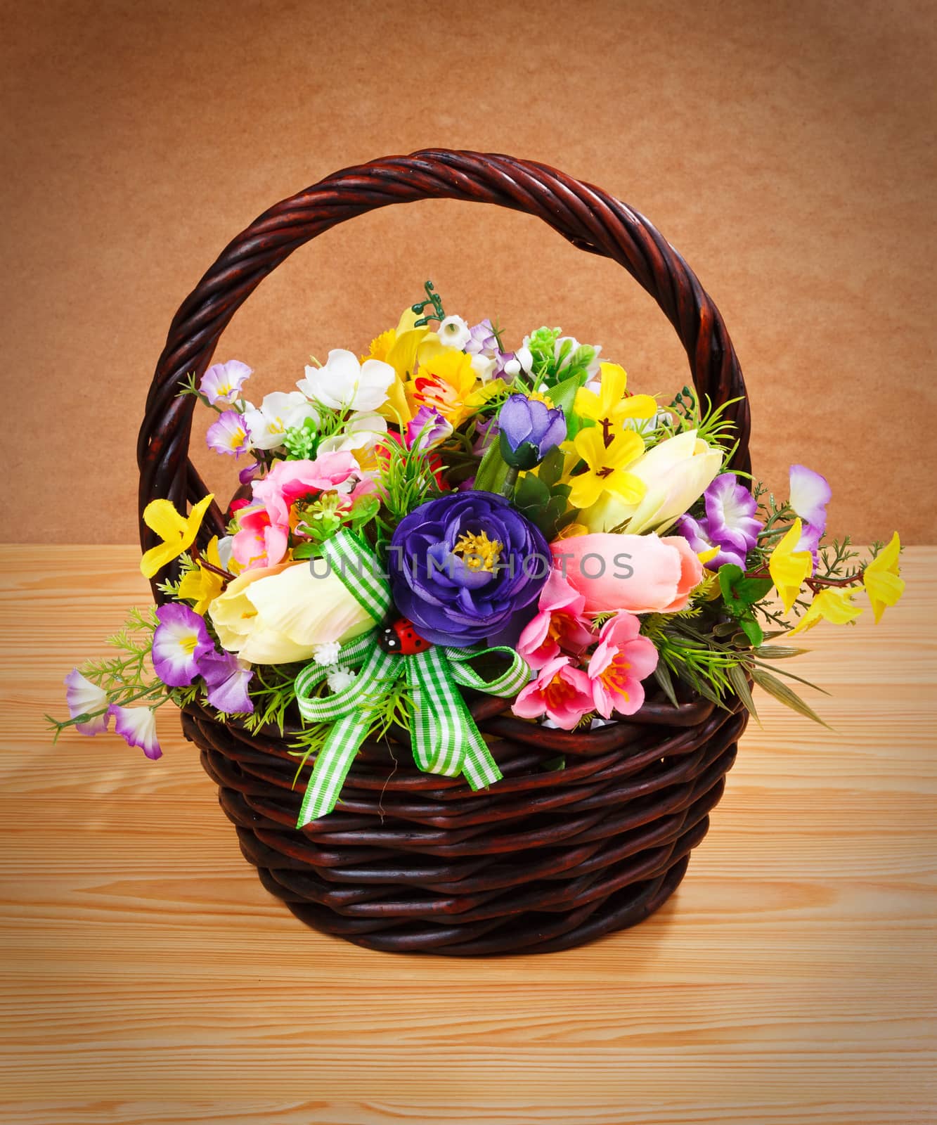 Beautiful flowers in a basket isolated on white
