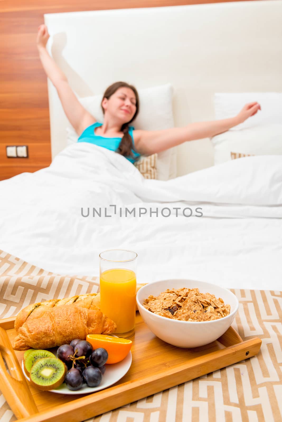 a tray of food in focus and stretches girl