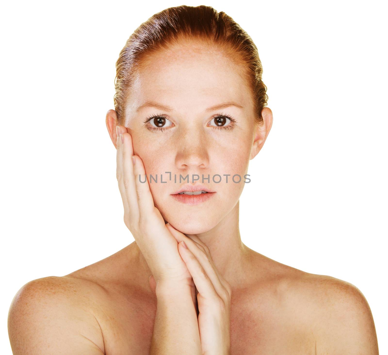 Calm beautiful young Caucasian female with hand on cheek