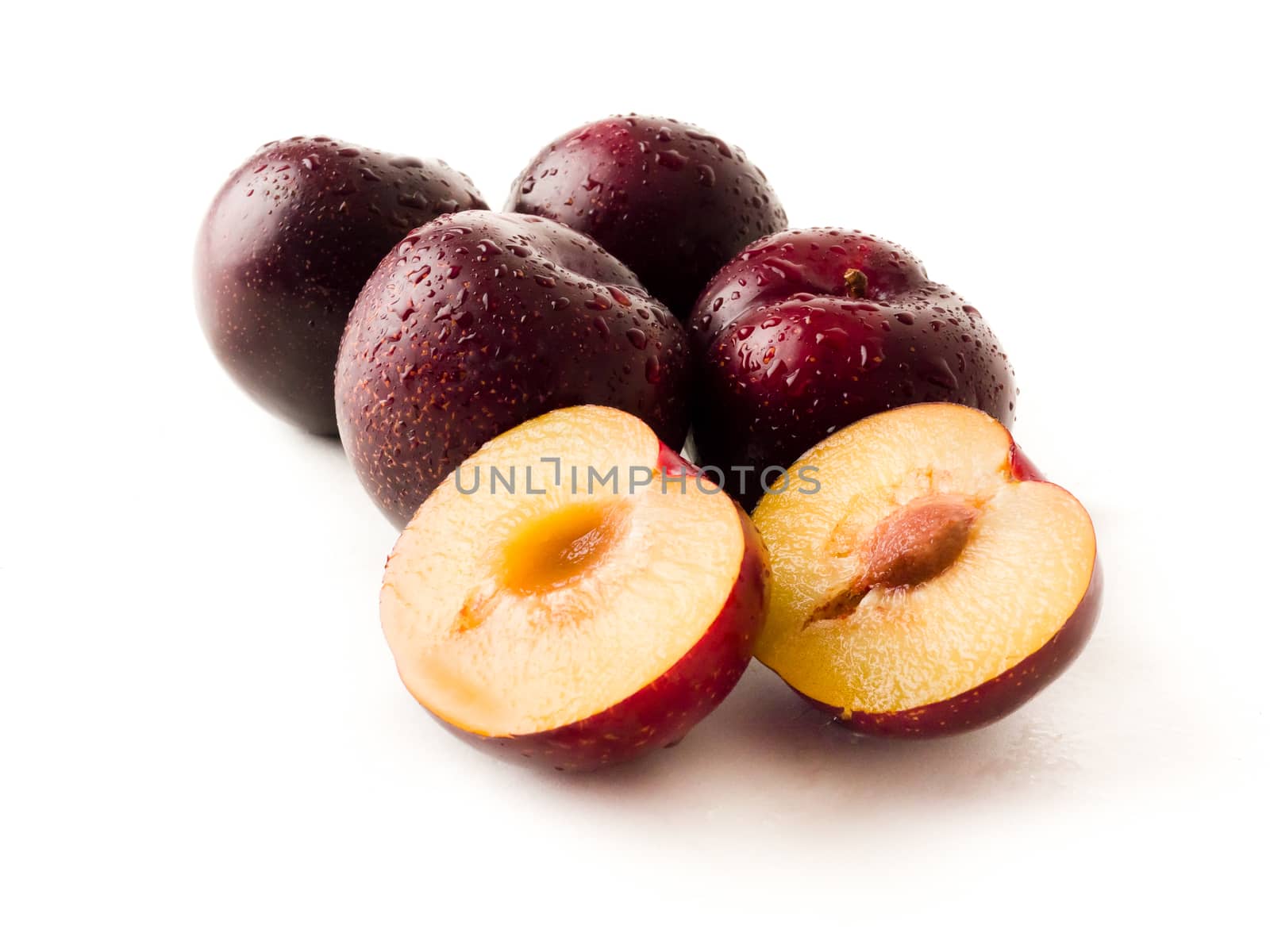 Bundle of red plums on a isolated white background.