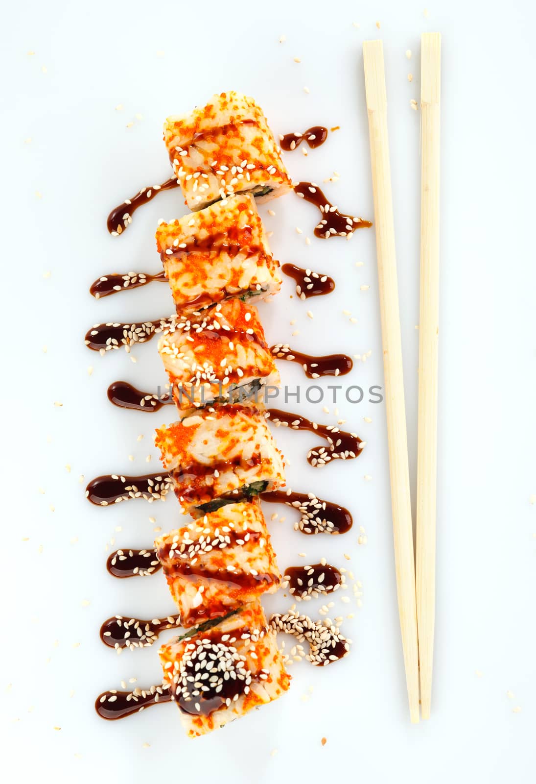 japanese sushi rolls with sauce and  Chopsticks on a white background