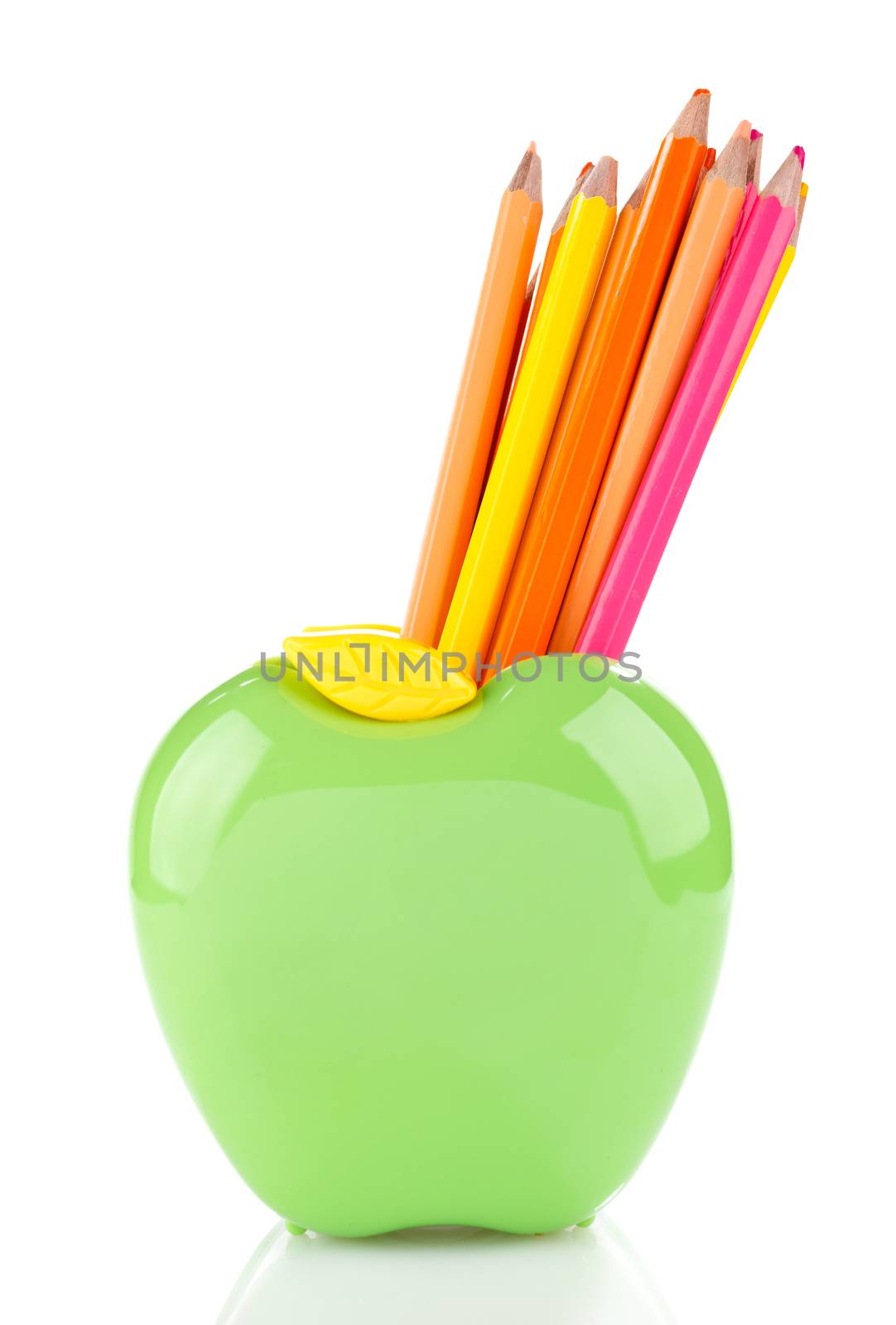 color pencils in green apple shaped holder isolated on white