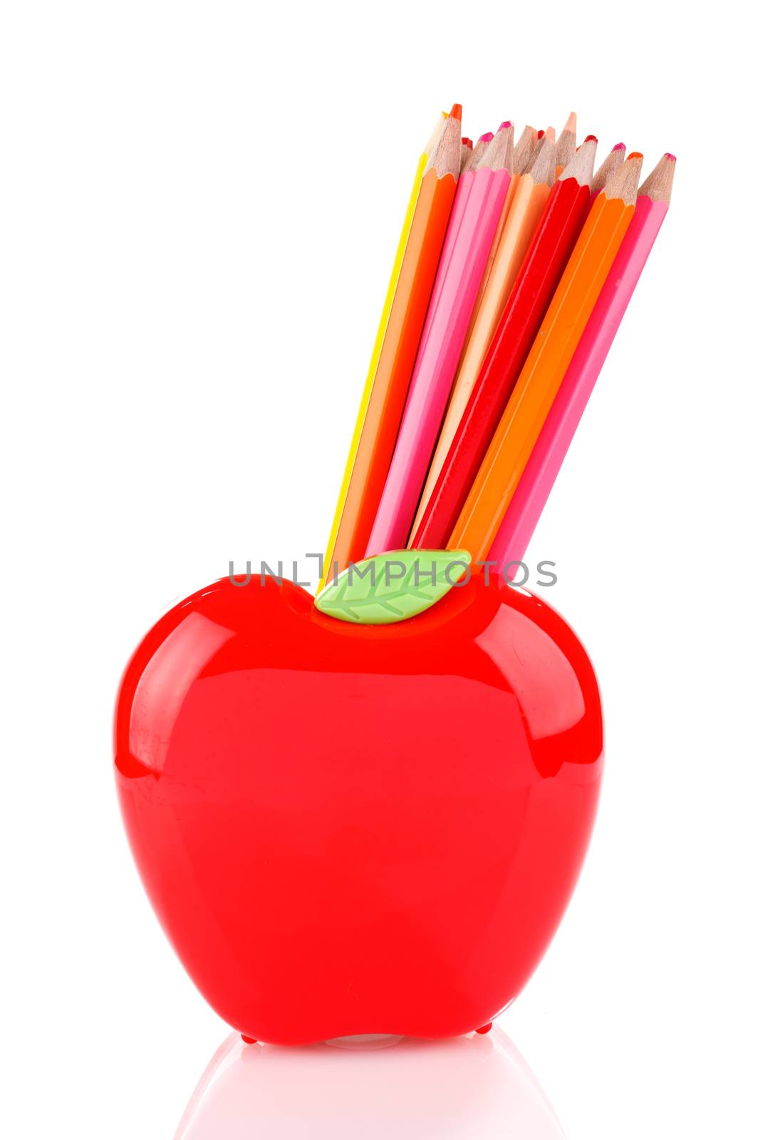 Colorful pencils in red apple shaped holder isolated on white
