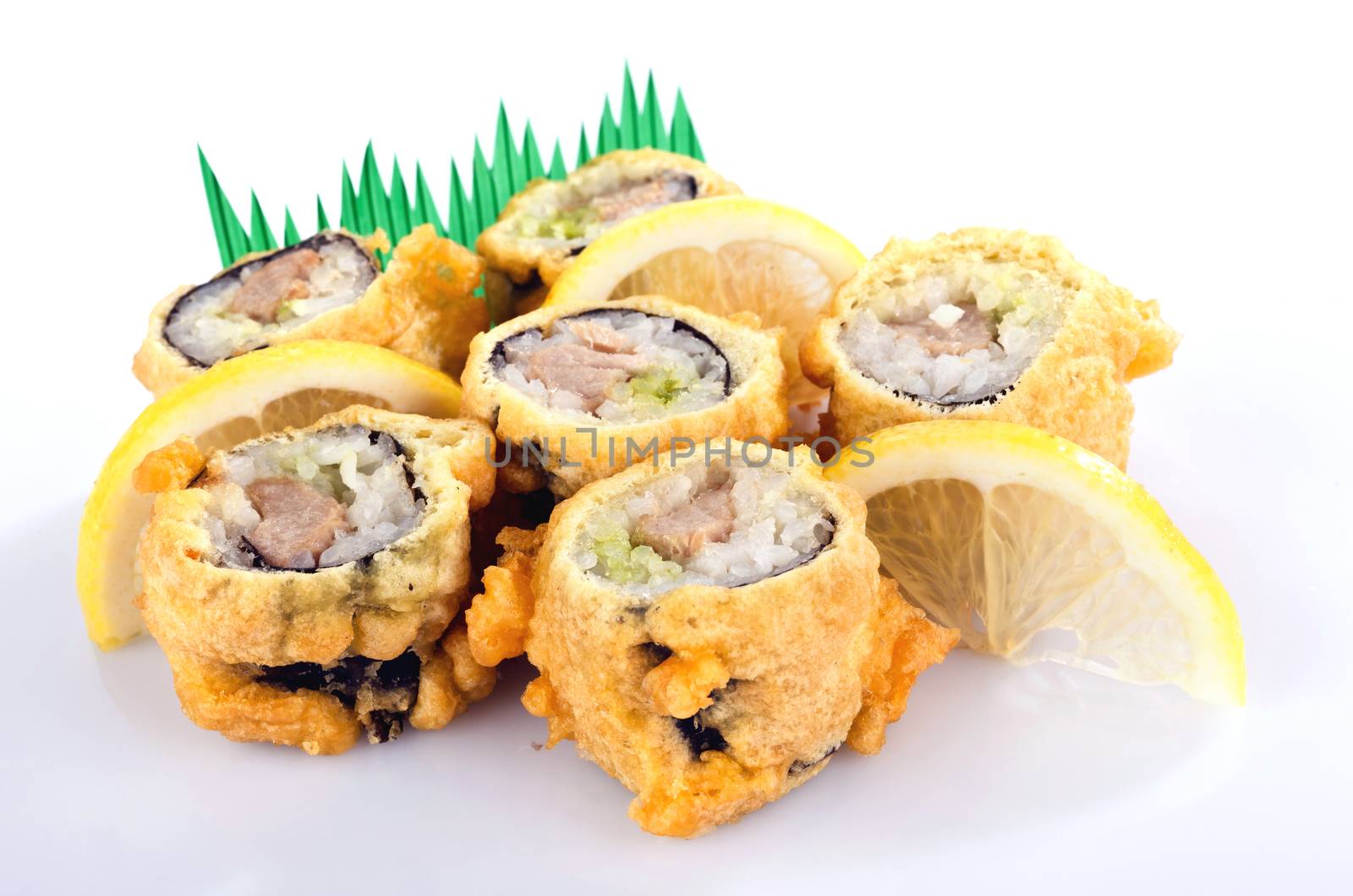 sushi roll fried in tempura batter with lemon isolated