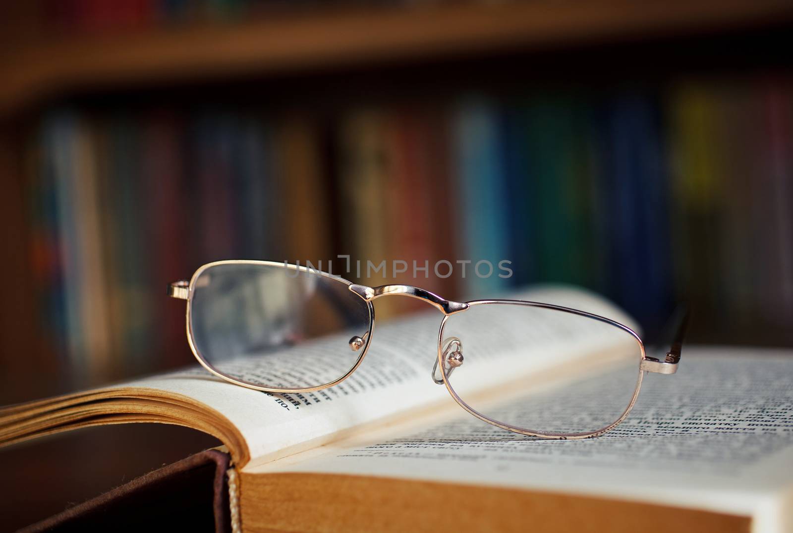 glasses and book in the library