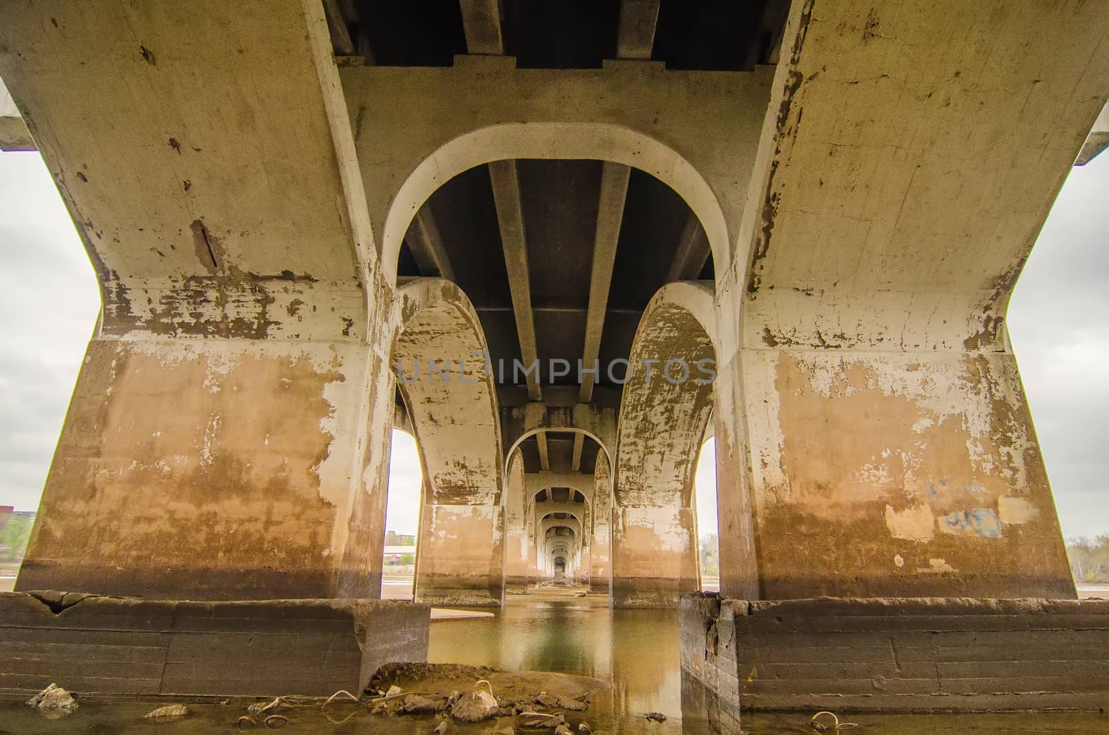 standing under old bridge over the river