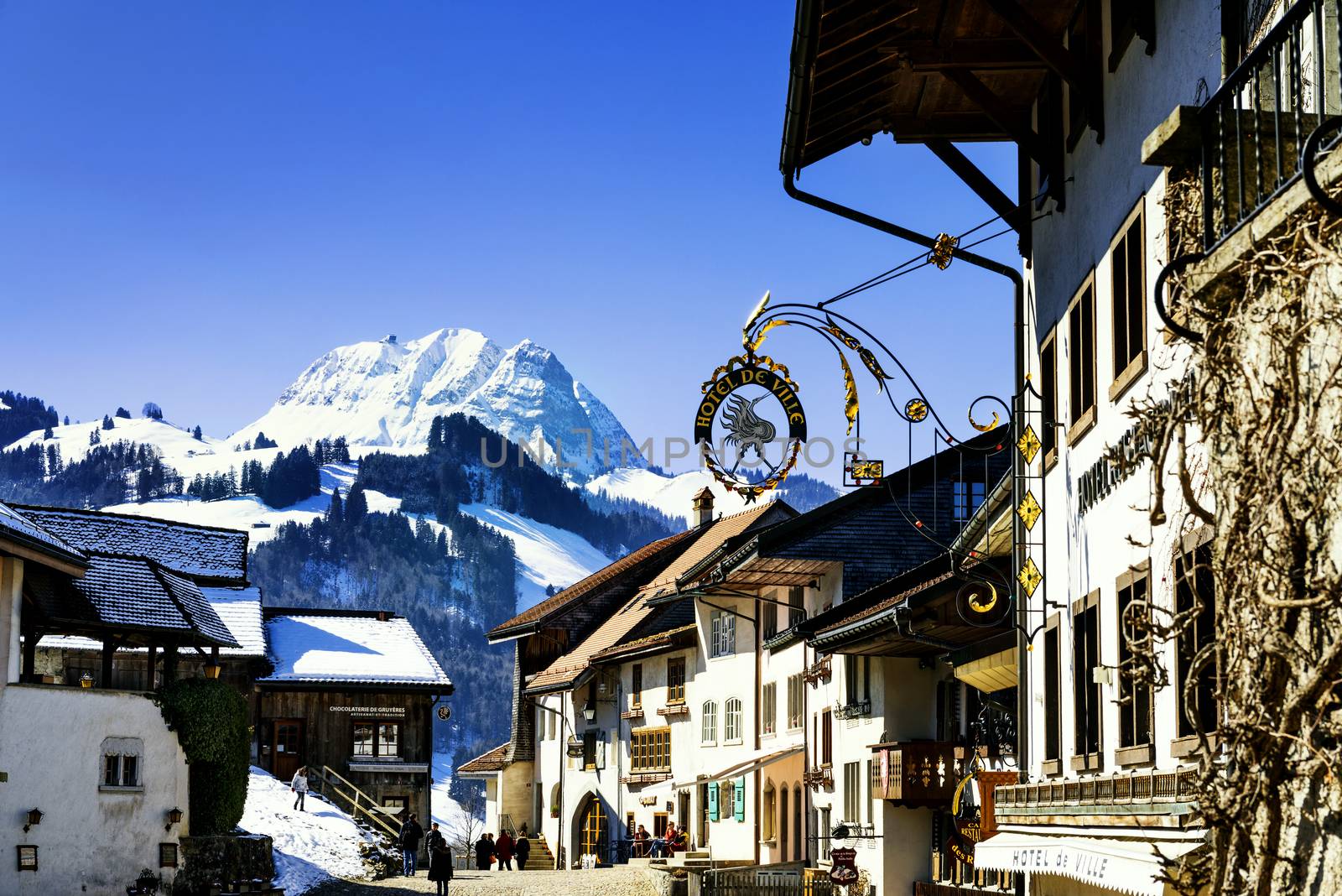 GRUYERES, SWITZERLAND - MARCH 03, 2015: View of the main street in the swiss village Gruyeres, Switzerland . The town and region are famous for their Swiss Cheese called Gruyere.