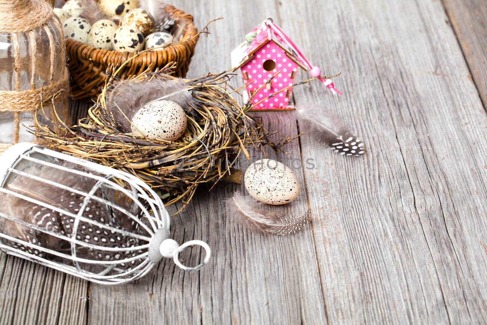 easter decoration on wooden background with color egg and with birdhouse,