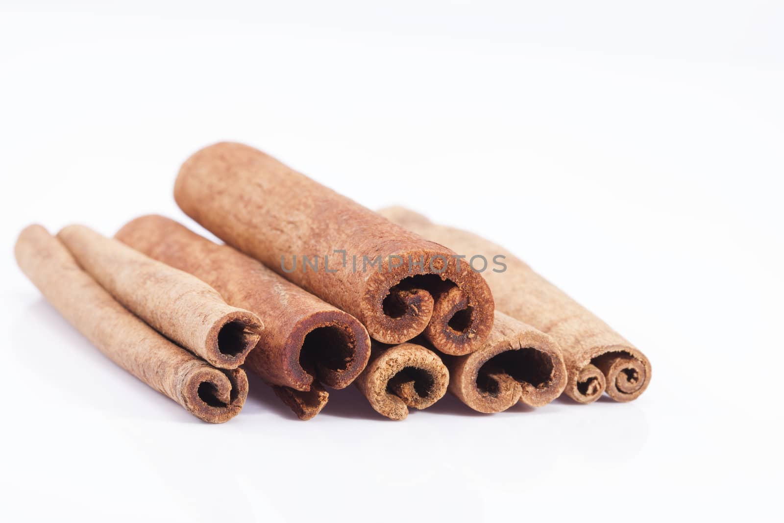 group of dried cinnamon stics isolated on white background