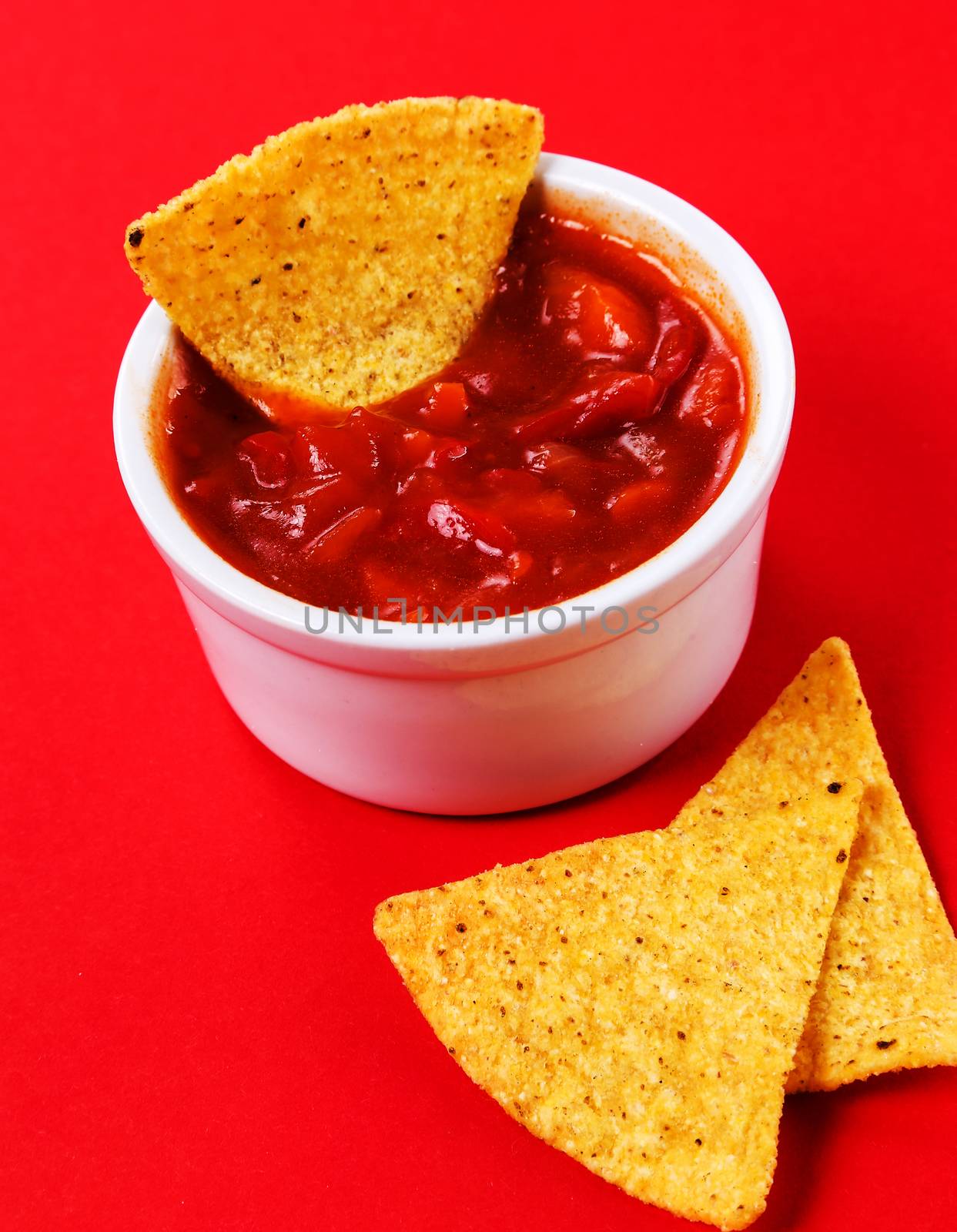 Potato chips with sauce on a red background