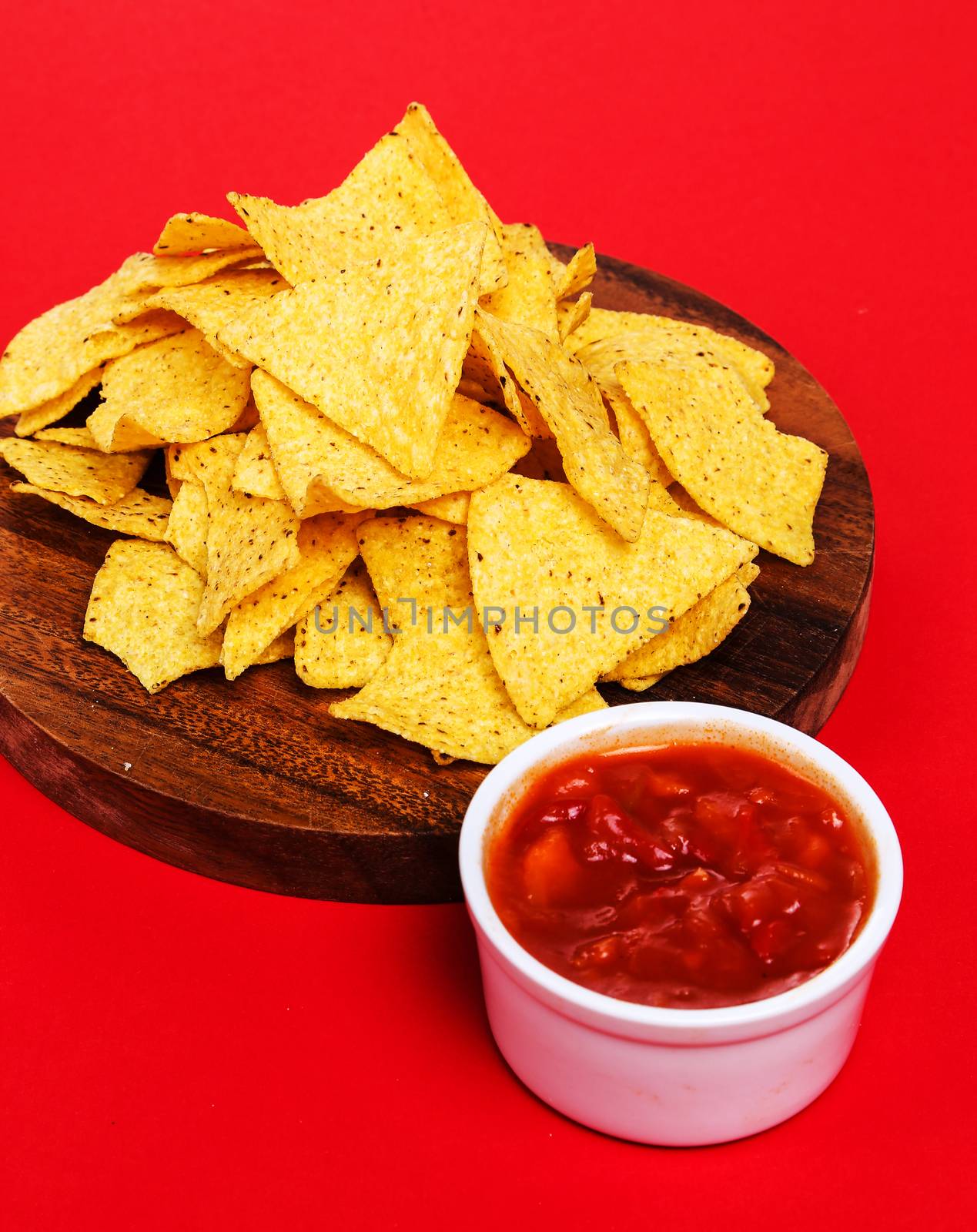 Potato chips with sauce on a red background