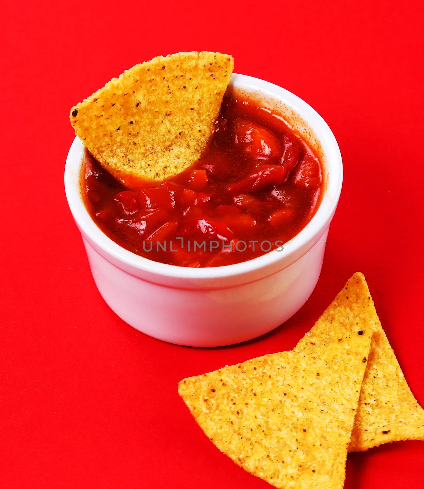 Potato chips with sauce on a red background