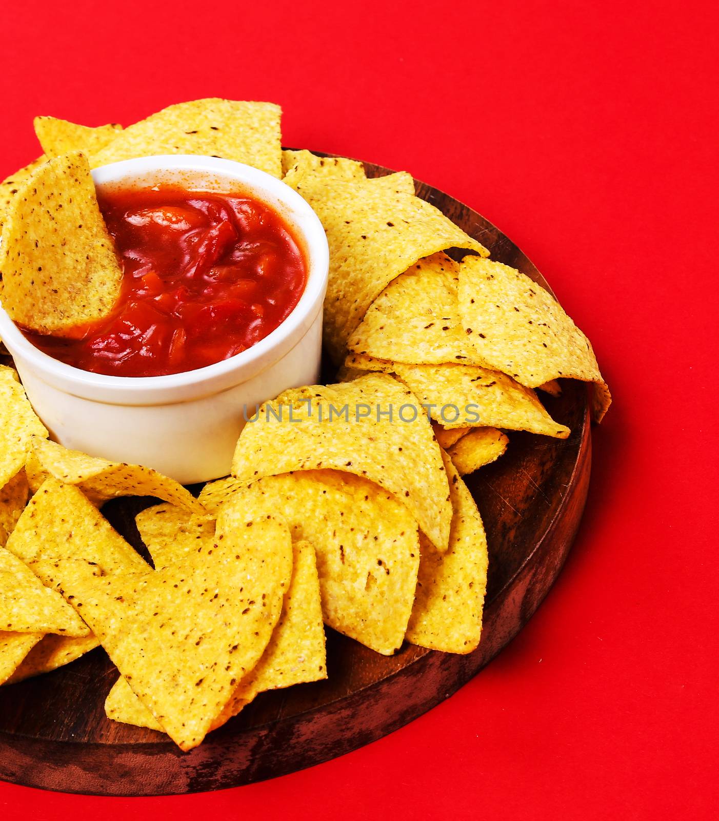Potato chips with sauce on a red background