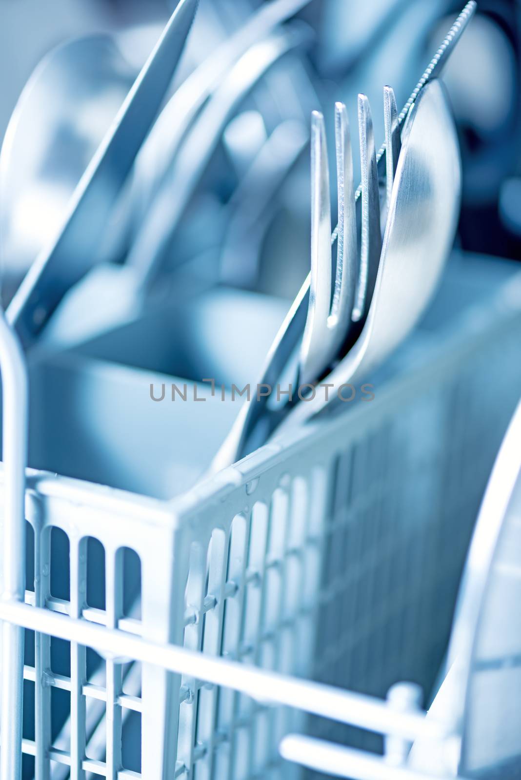 Clean kitchenware in dishwasher by Nanisimova