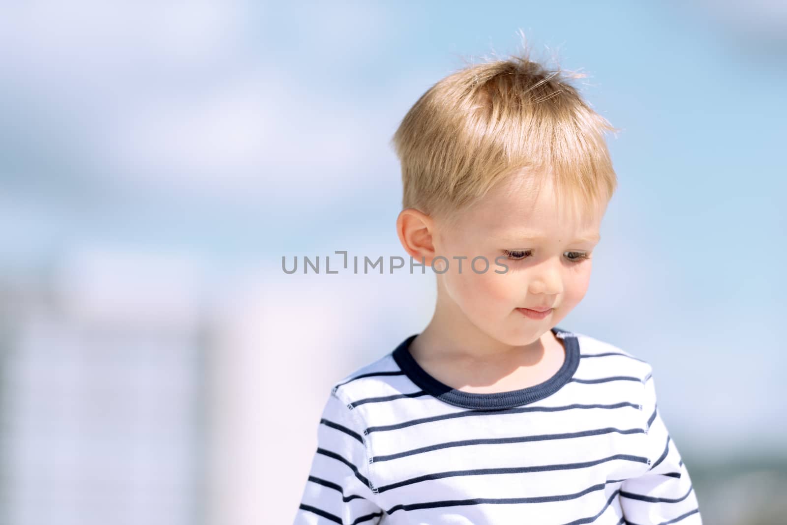 Portrait of little preschool boy outdoors close up by Nanisimova