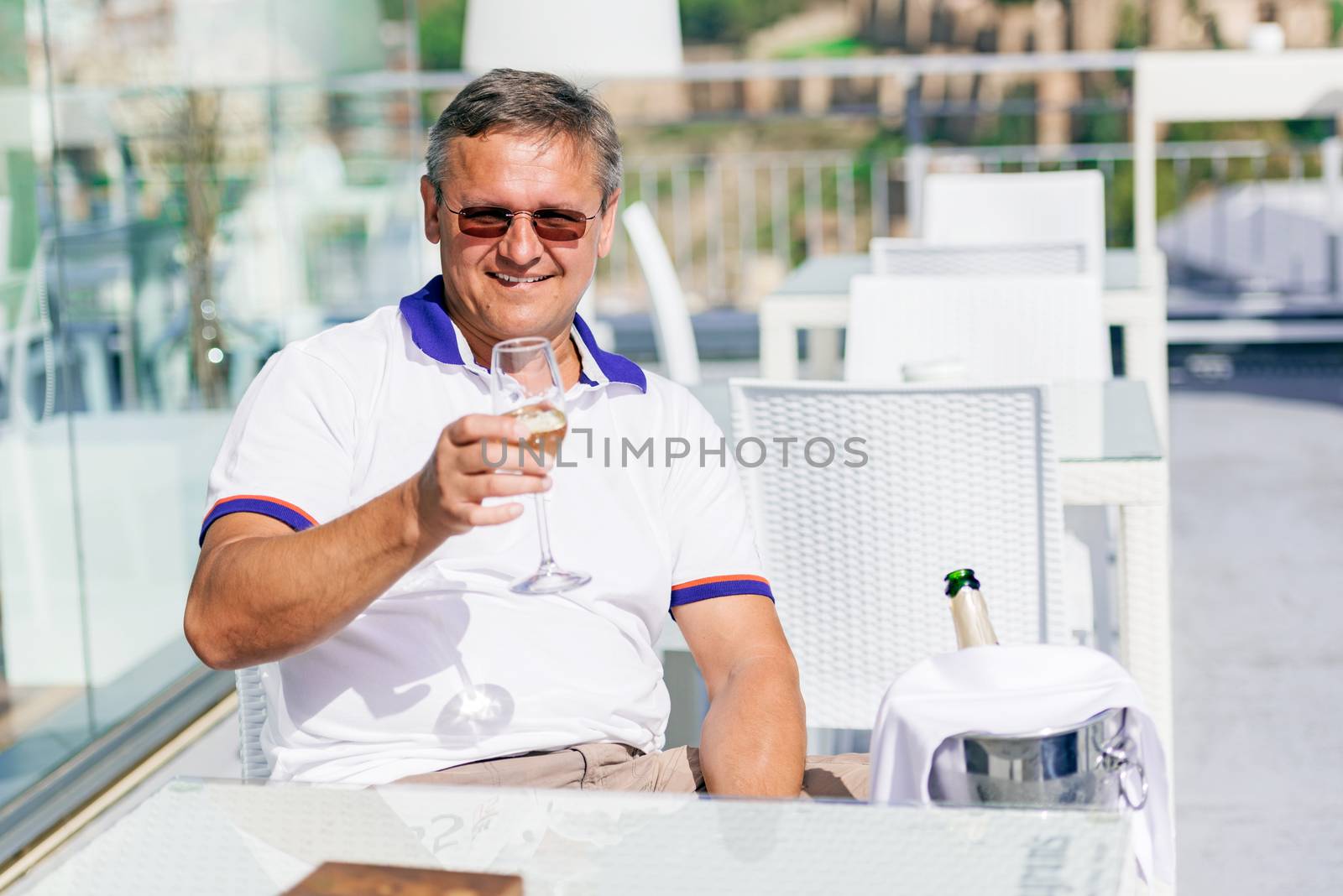 Men with a glass of champagne at street restaurant