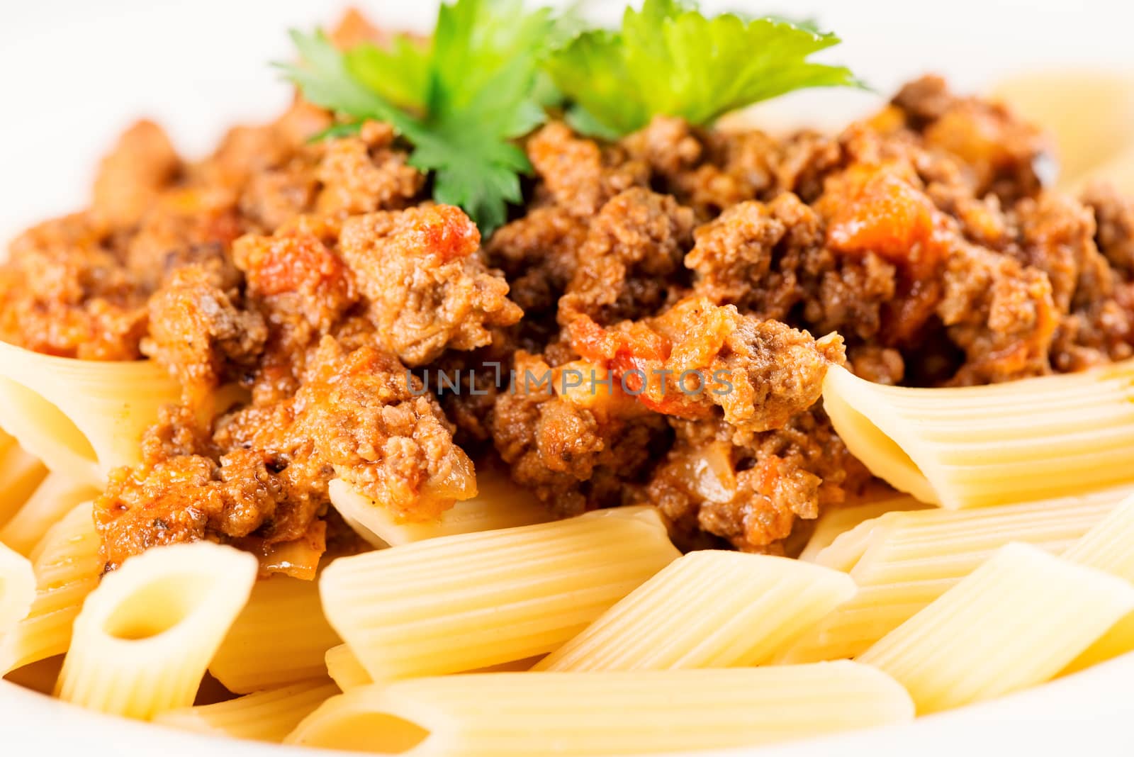 Pasta. Penne Pasta with Bolognese Sauce, Parmesan Cheese and Basil, Fork. Italian Cuisine. Mediterranean food