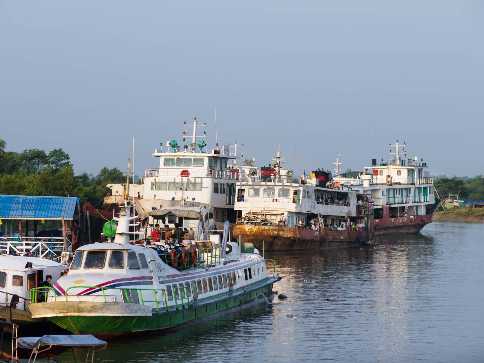 Sittwe, Rakhine State, Myanmar - October 16, 2014: Ferries waiting to take passengers up the rivers of the Rakhine State at the harbour of Sittwe in Myanmar.