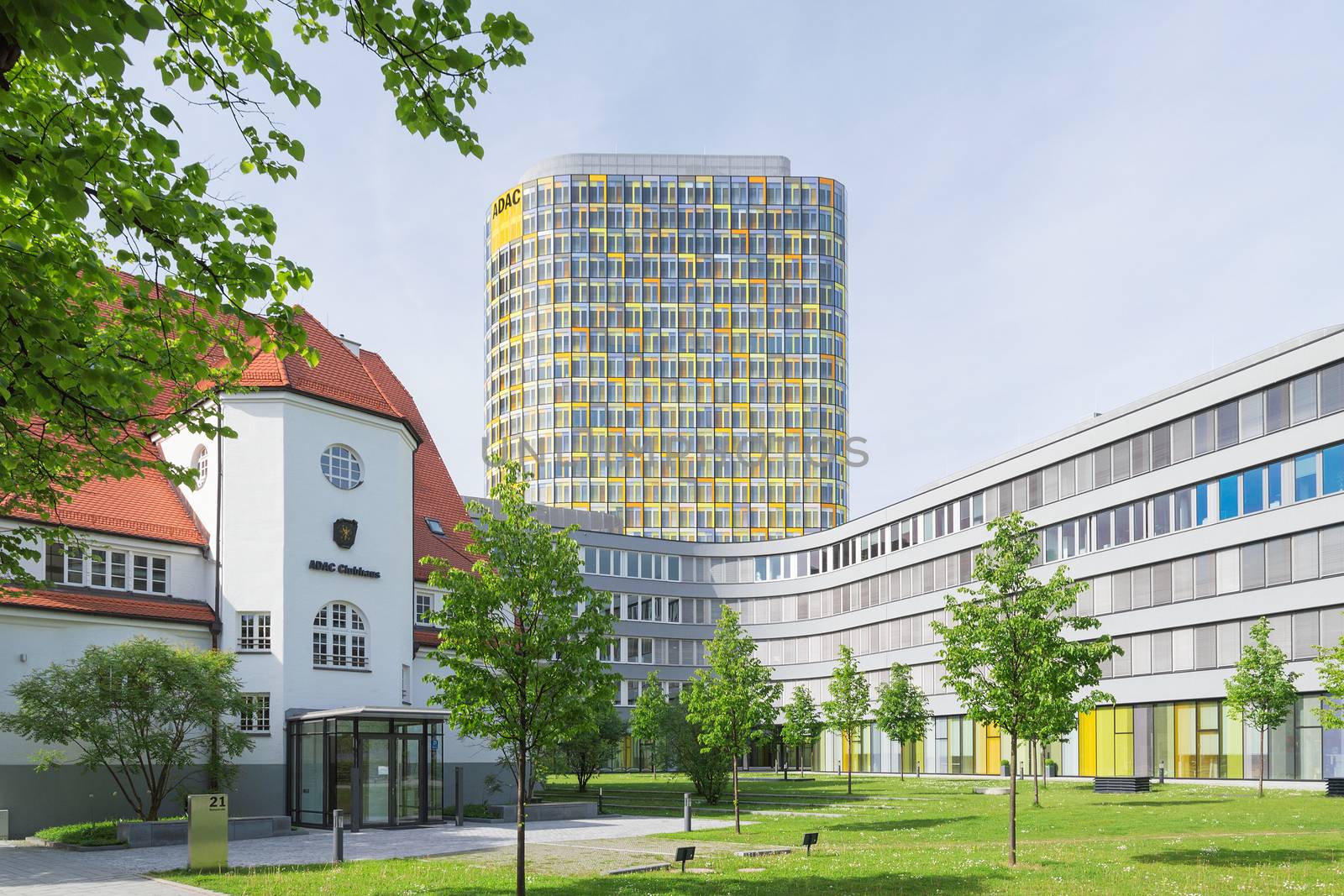 Munich, Germany - May 12, 2015: Old small clubhouse and the new ADAC Headquarters with 18-storey office tower rises above a 5-storey base which accommodates 2,400 employees.