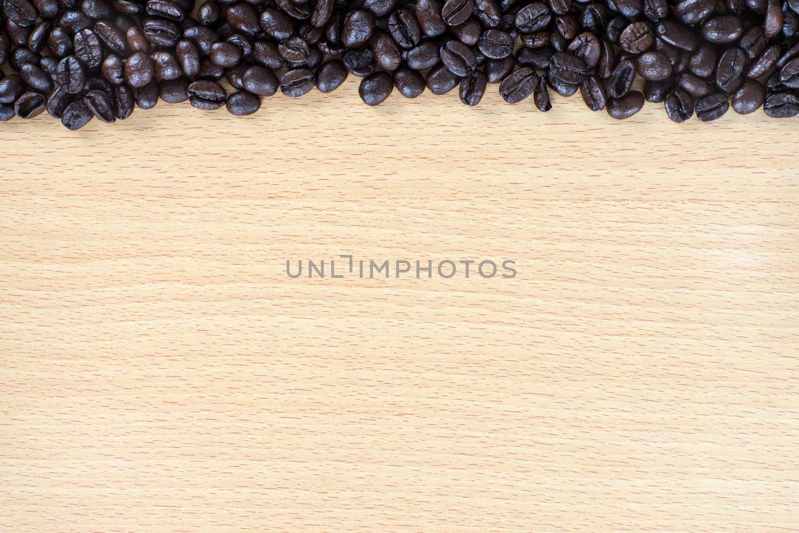 Coffee bean on wood background with space for text