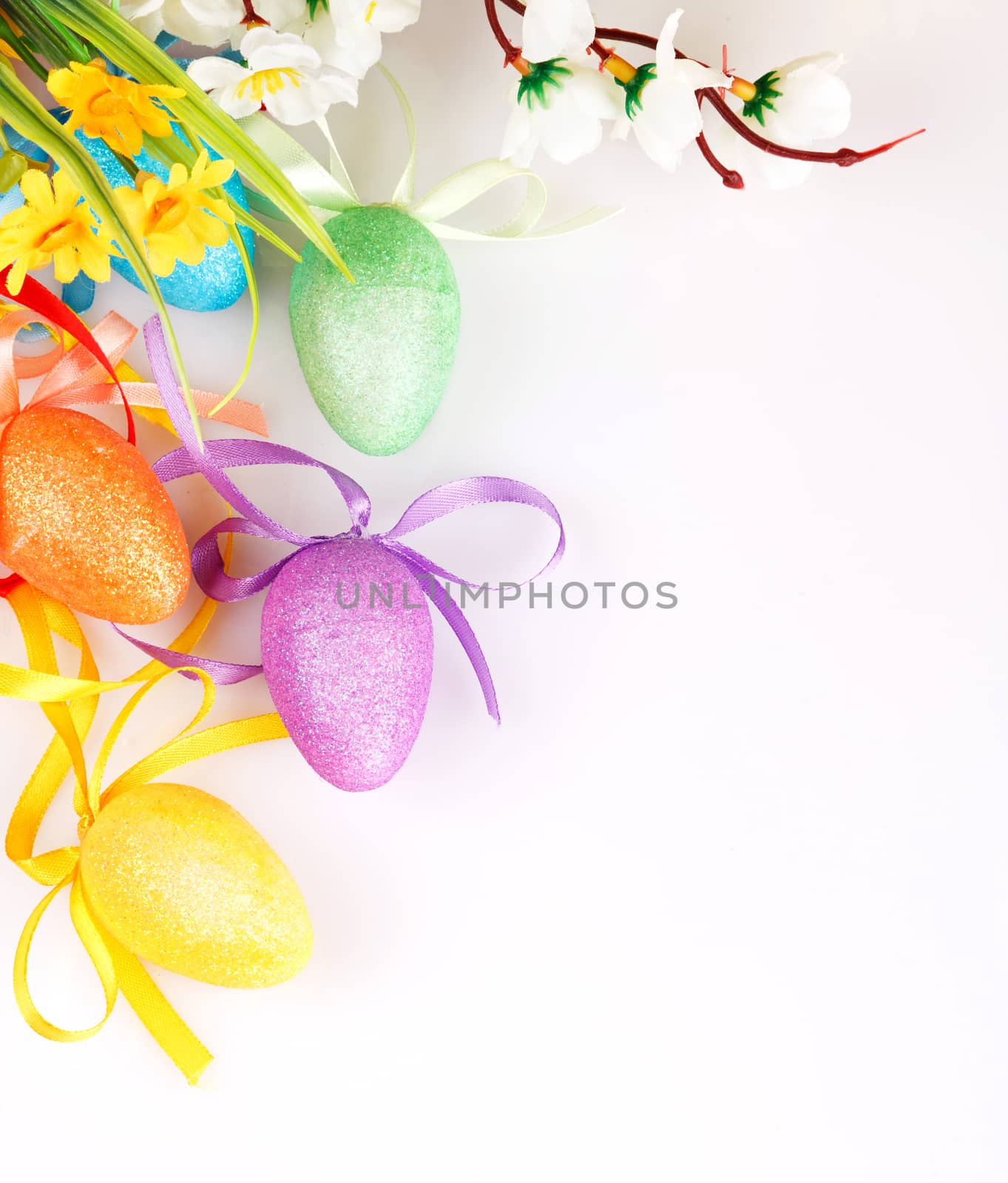 colored easter eggs with flowers on a white background with space for text