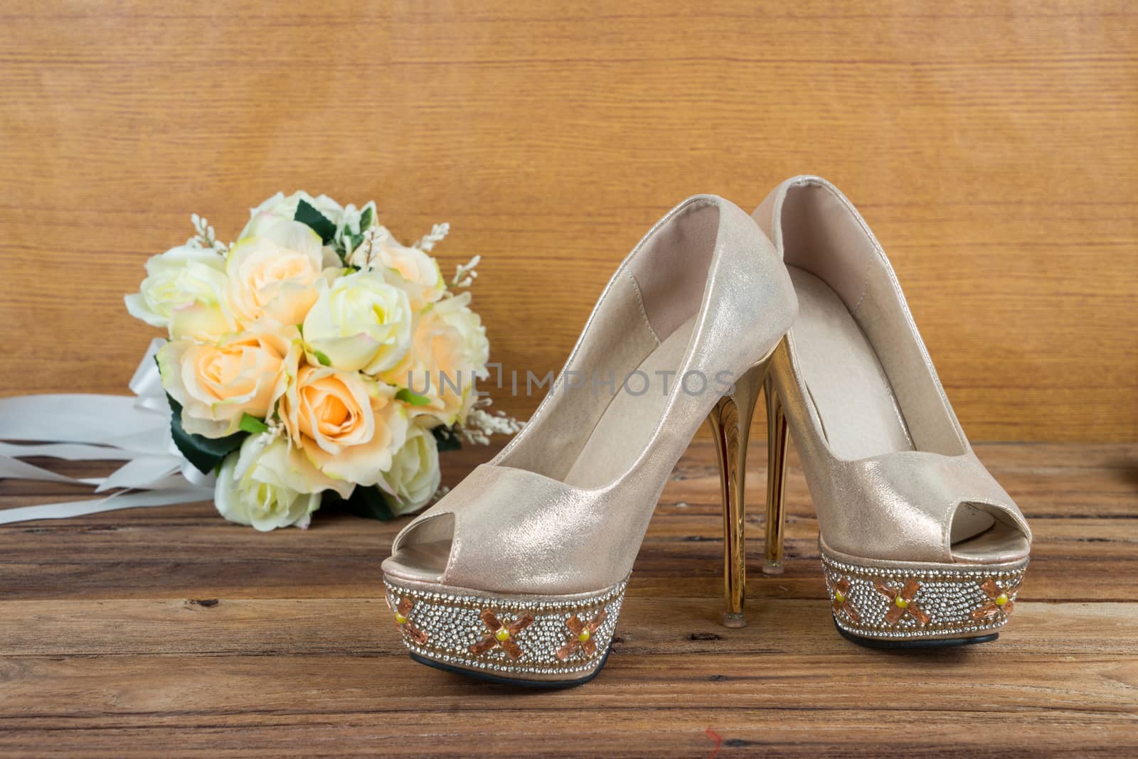 Wedding bouquet with bride's shoes on wood background by iamway