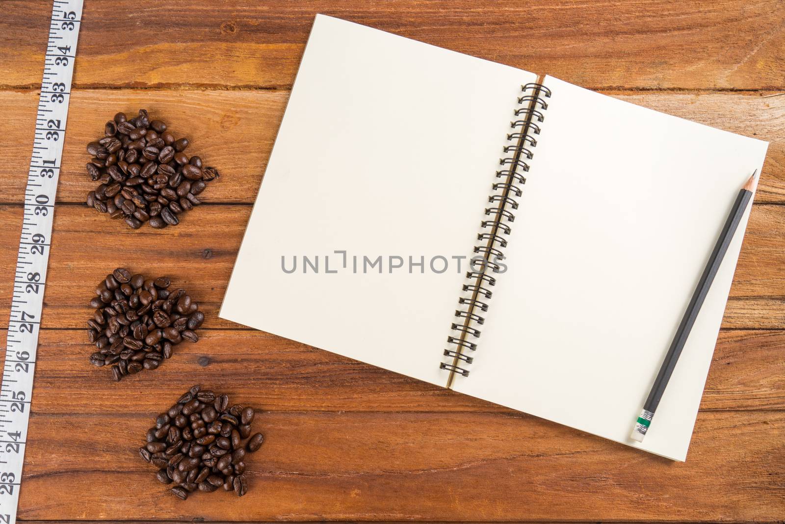Wooden Clipboard attach planning paper with pencil beside coffee by iamway