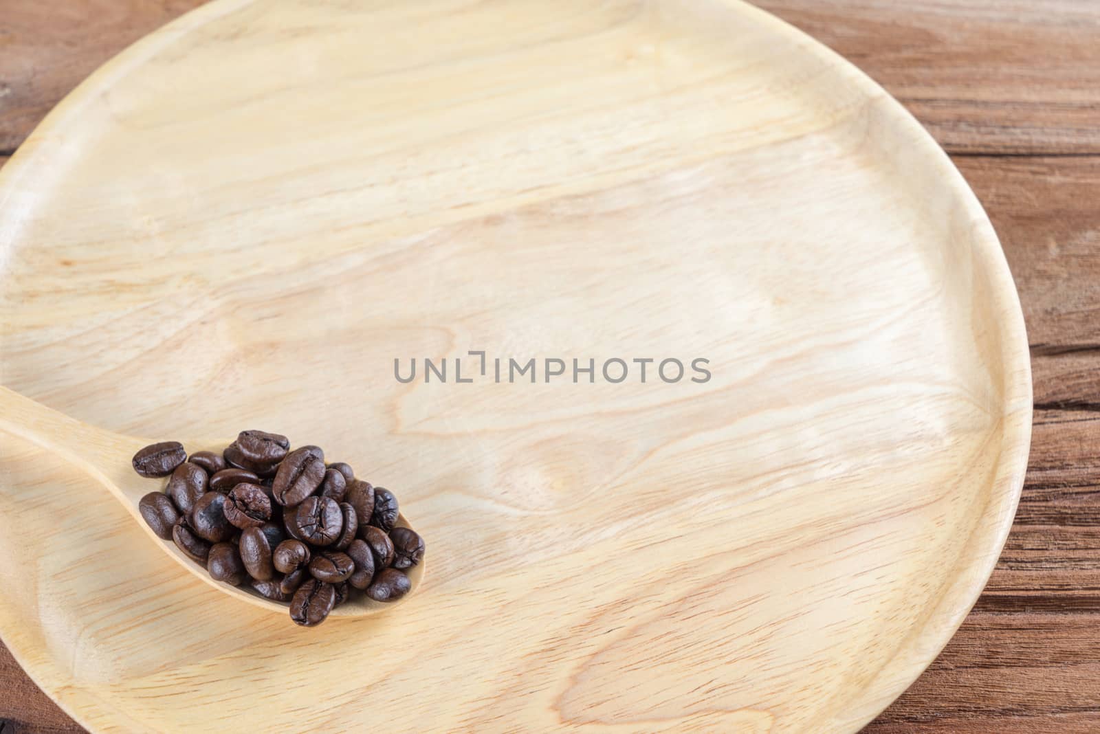 Coffee bean on wooden spoon, dish, table background by iamway